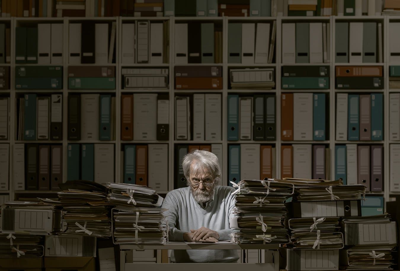 An accountant surrounded by binders and files