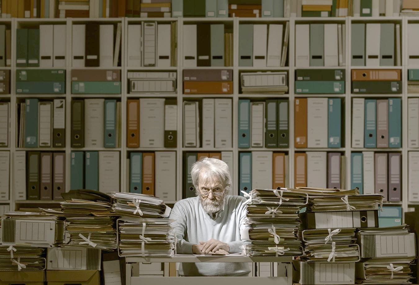 An accountant surrounded by binders and files