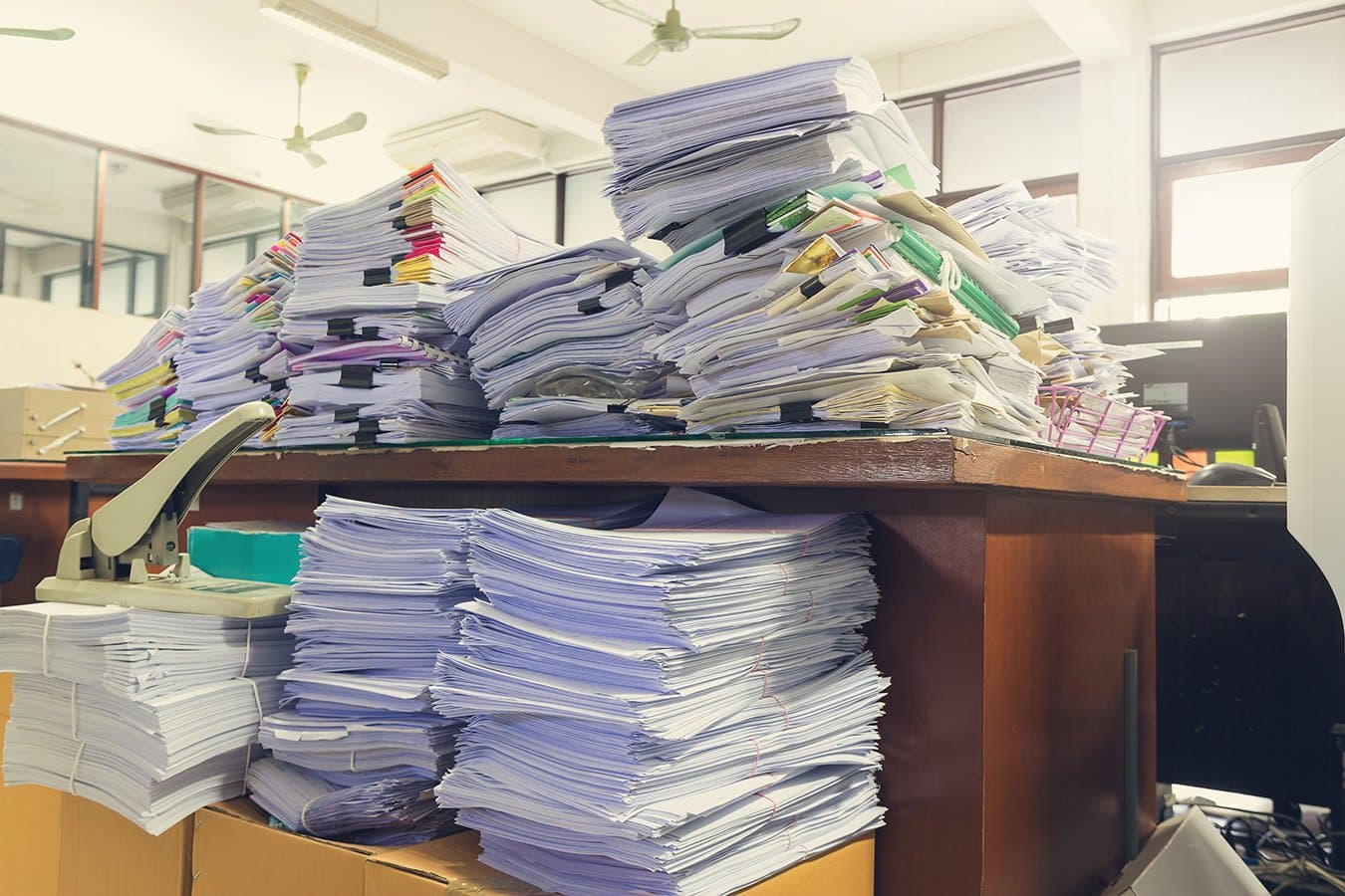 Stacks of paperwork on an accountant's desk